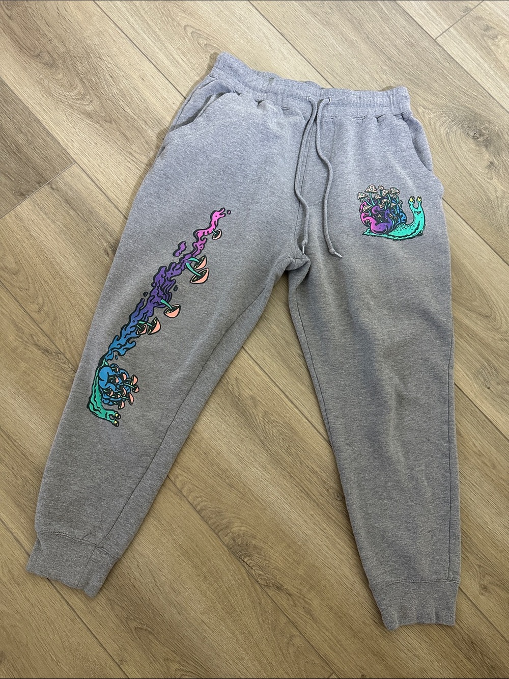 A-LAB Large Gray Sweat Pants with prints of psychedelic snails and mushrooms.